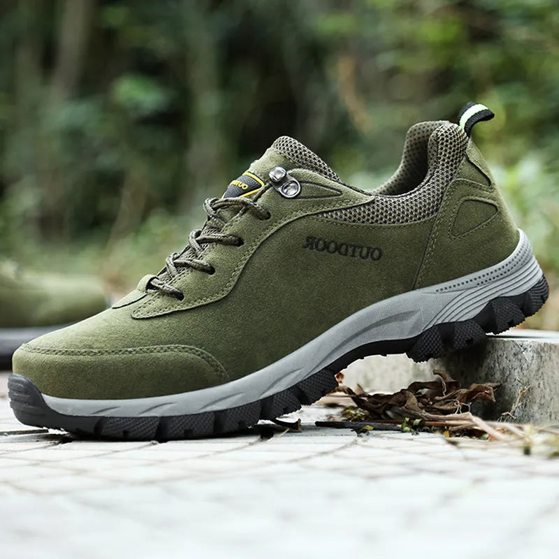 Men's low-top hiking shoe in army green with mesh upper on a natural surface