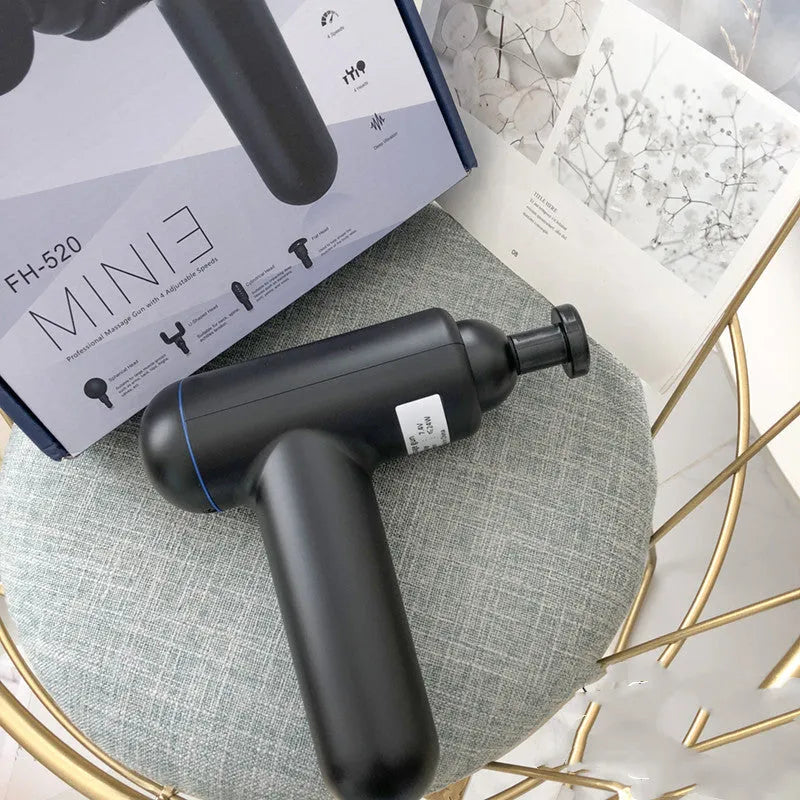 Black fascia gun massager with USB charging port shown alongside red and white colour variants