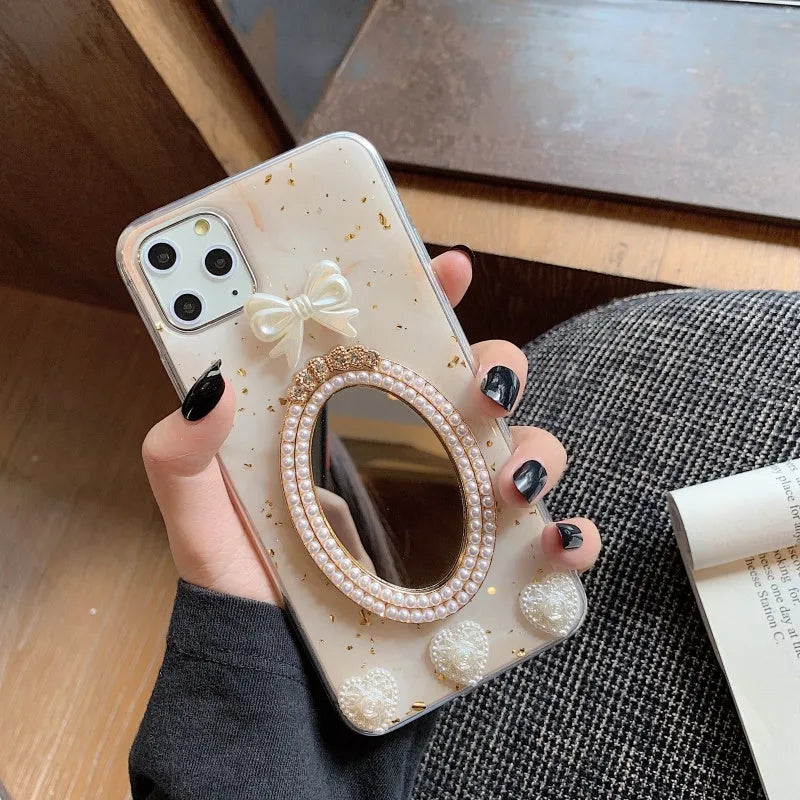 Brown marble silicone iPhone case with a rhinestone bowknot and a small circular mirror on the back.