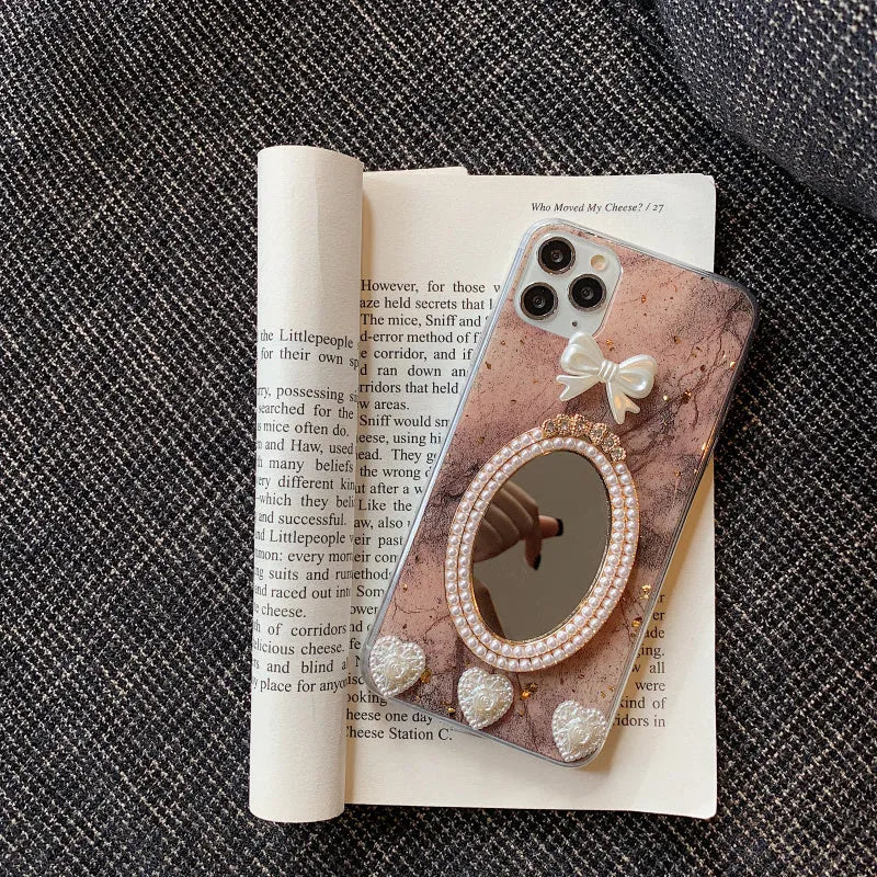 Brown marble silicone iPhone case with a rhinestone bowknot and mirror detail.