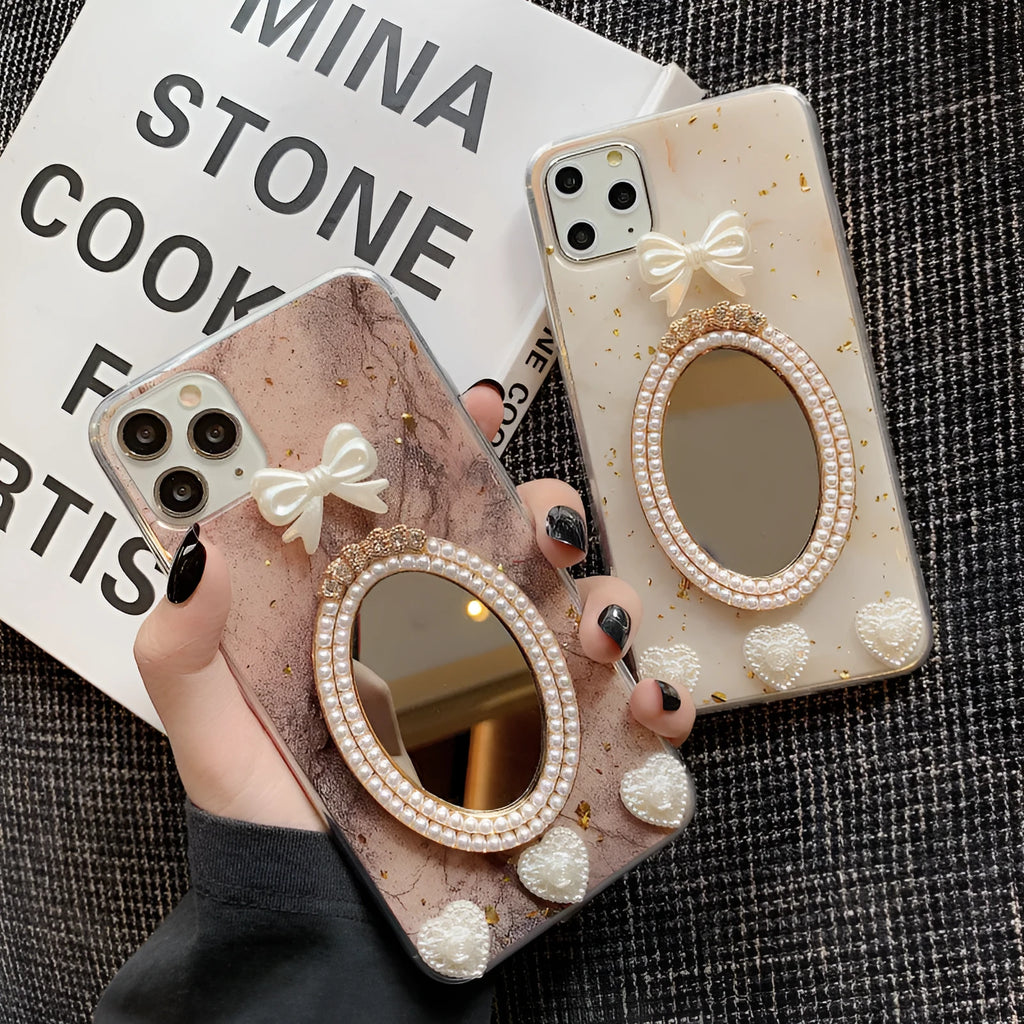 Brown marble silicone iPhone case with a rhinestone bowknot and a small circular mirror on the back.