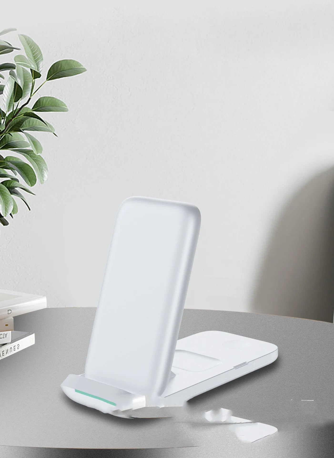 Black foldable three-in-one wireless charger for iPhone, Apple Watch and AirPods showing LED light.