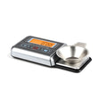 Digital electronic precision scale with 100g capacity and 0.005g accuracy on a flat surface.