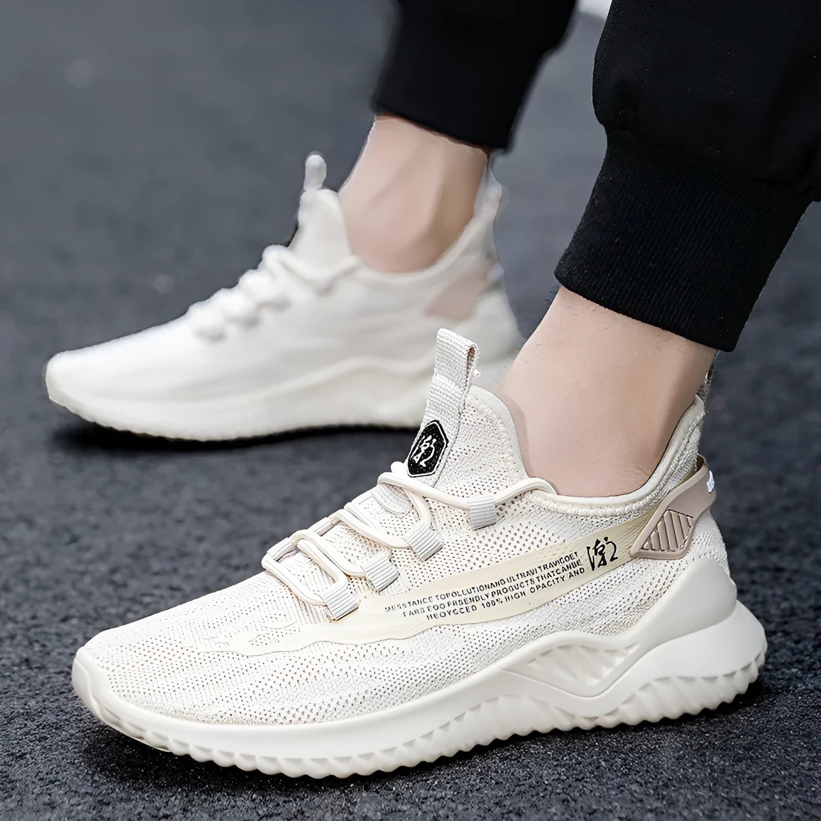 Men's white low-top mesh sports shoe with round toe and rubber sole on a plain background