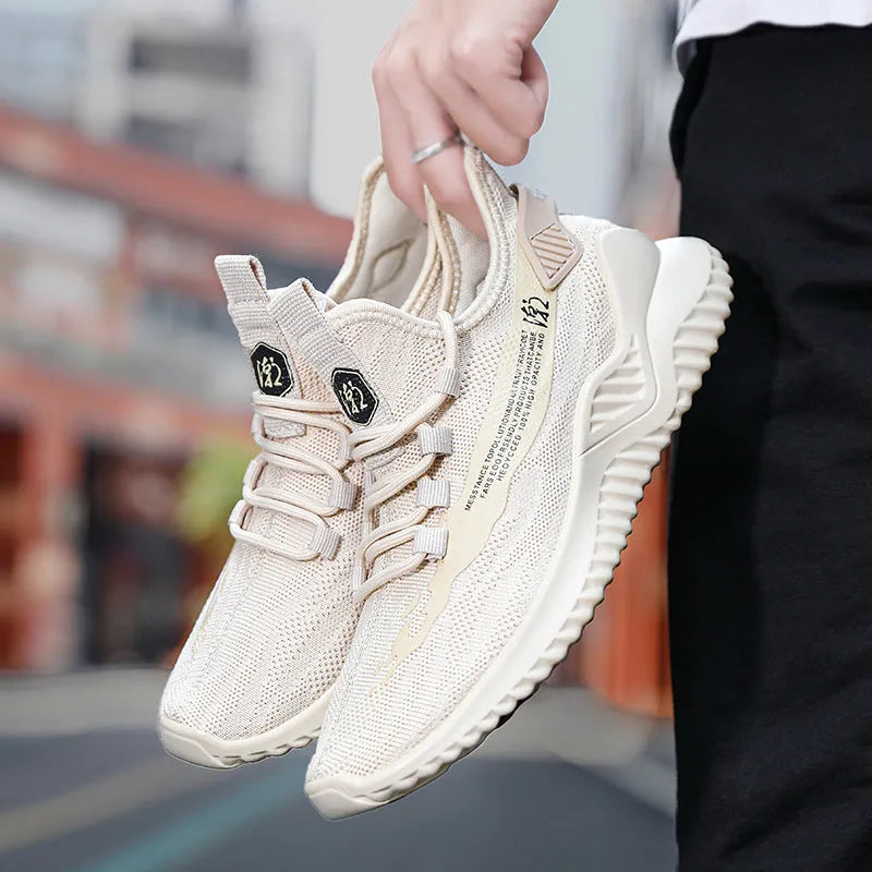 Men's white low-top mesh sports shoe with round toe and rubber sole on a plain background