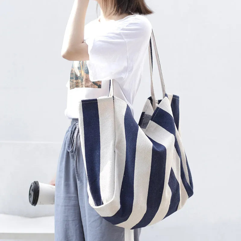 Striped canvas shoulder bag in black, blue, or red with 39cm bottom length, 35cm height, 21cm thickness, and certificate bag.
