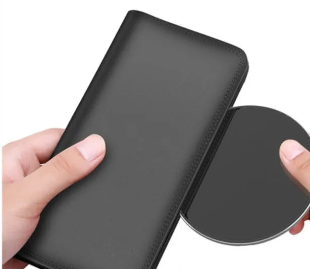 Ultra-thin aluminum wireless charging pad in silver colour on a wooden desk