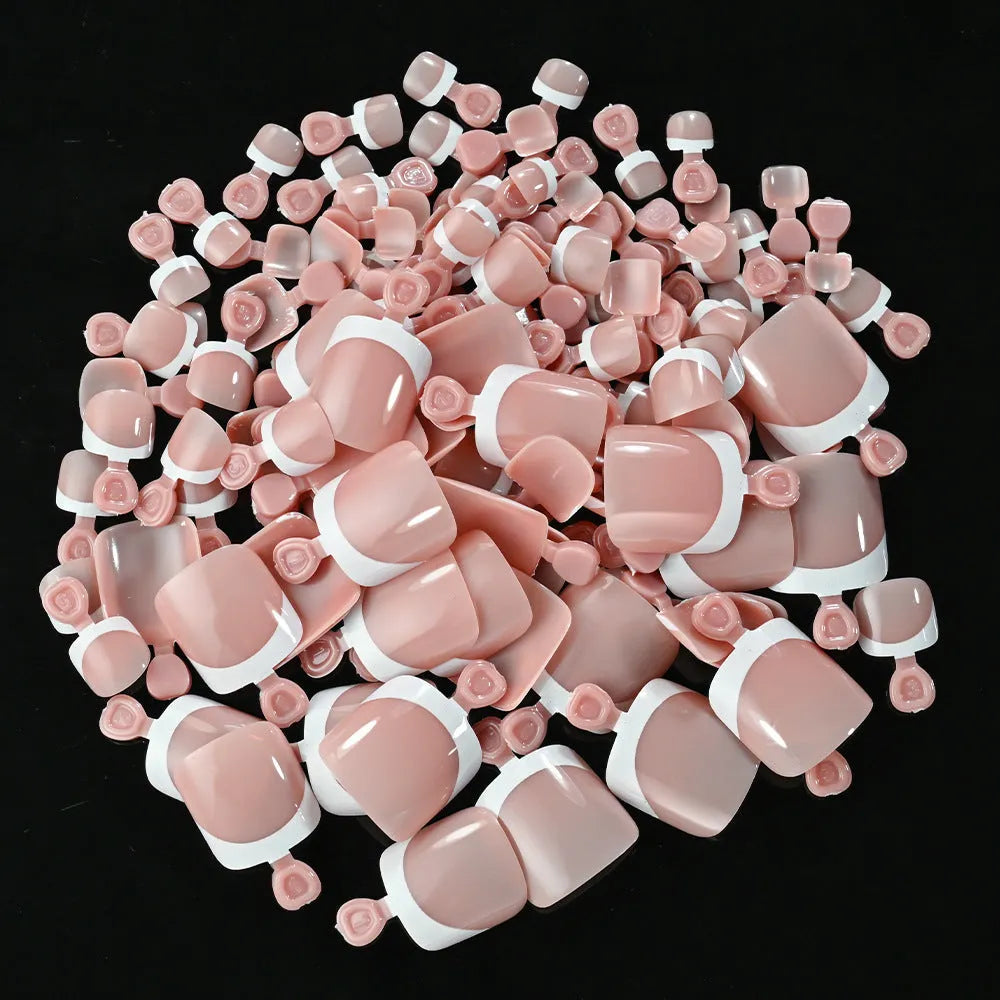 Box of 120 French white edge press-on toenails in nude colours on a full square short shape.