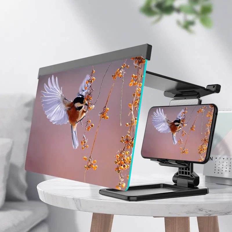 Black folding mobile phone screen amplifier with detachable holder next to an iPhone.