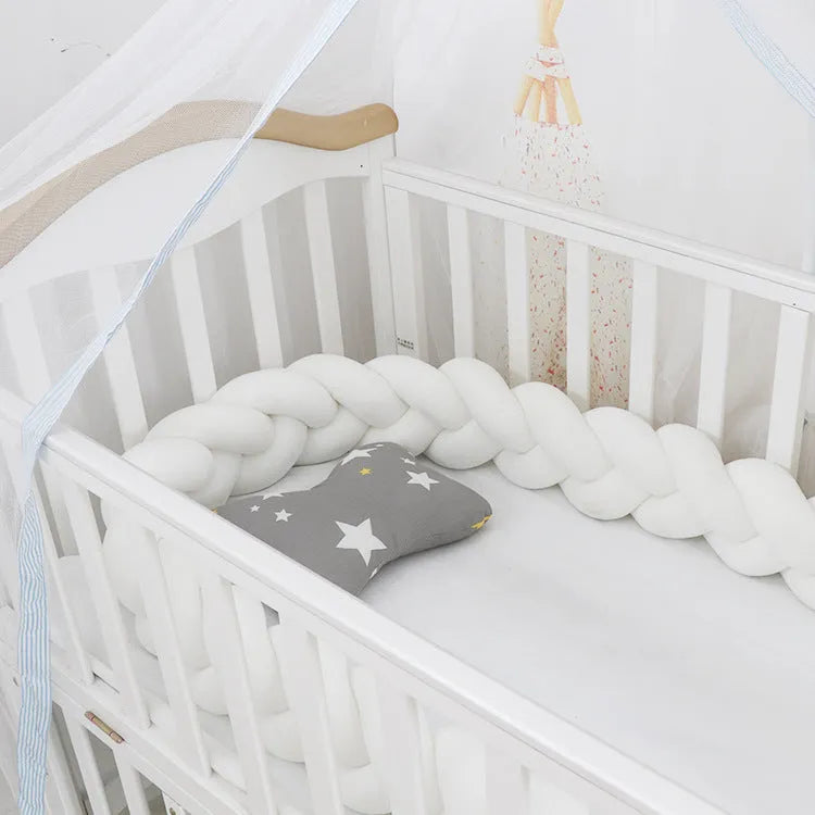Braided knot style baby cot bumper in spandex crystal velvet fabric, shown in a light grey colour.