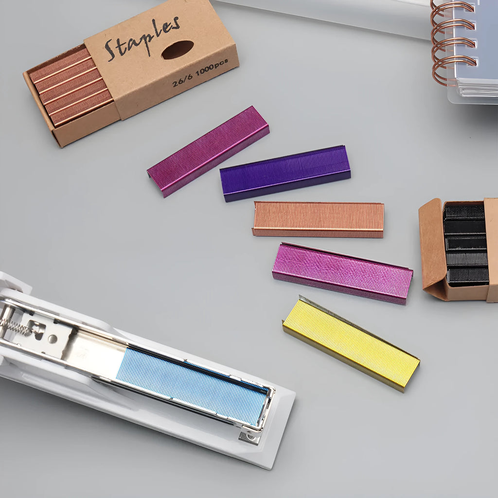 Box of 1000 metal office staples available in black, purple, rose gold, and rose red colours.