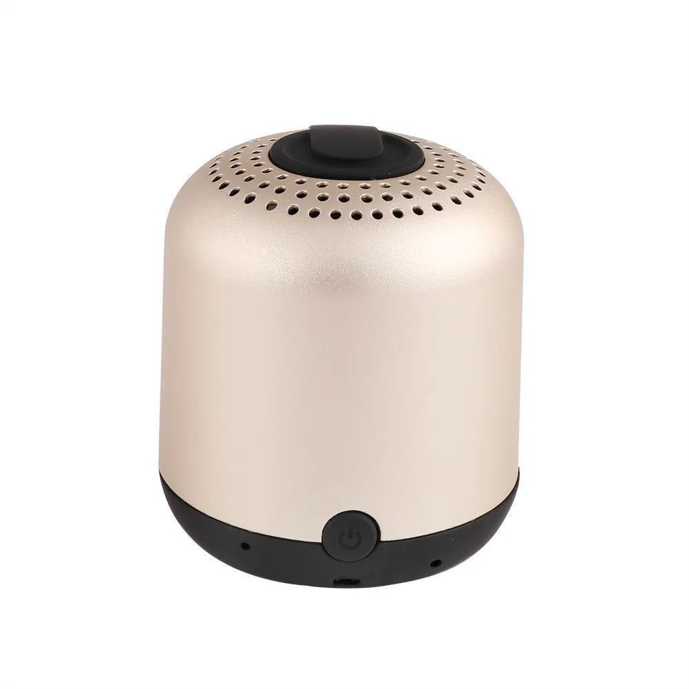 Hieha XQ11 cylinder-shaped portable Bluetooth speaker in silver colour on a table.