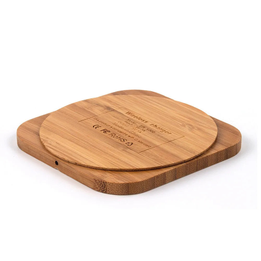 Square brown wooden bamboo 5W wireless charging pad for smartphones on a table.