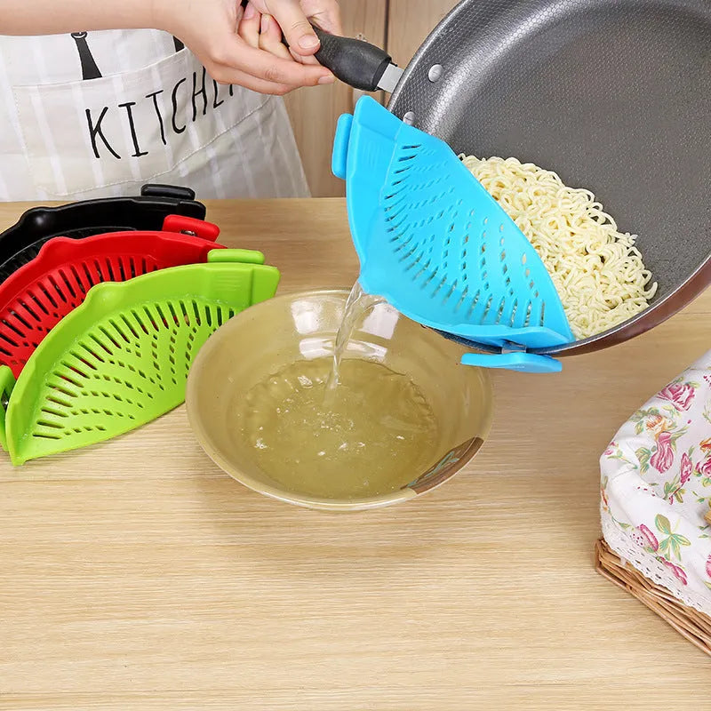 Silicone clip-on kitchen strainer with stainless steel filter mesh attached to a pot rim