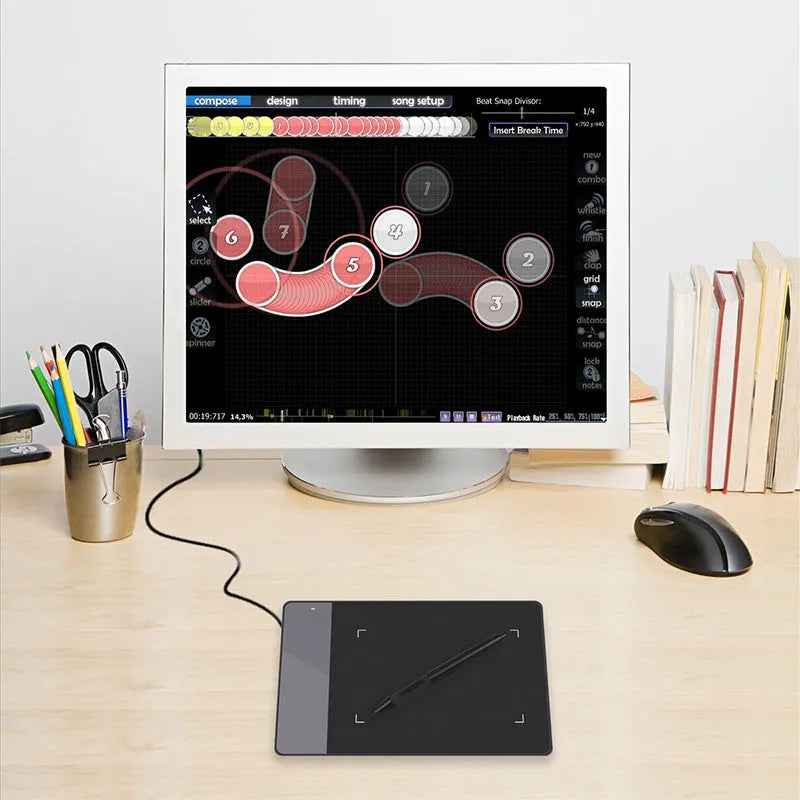 HUION 420 black electronic drawing board with USB cable on desk