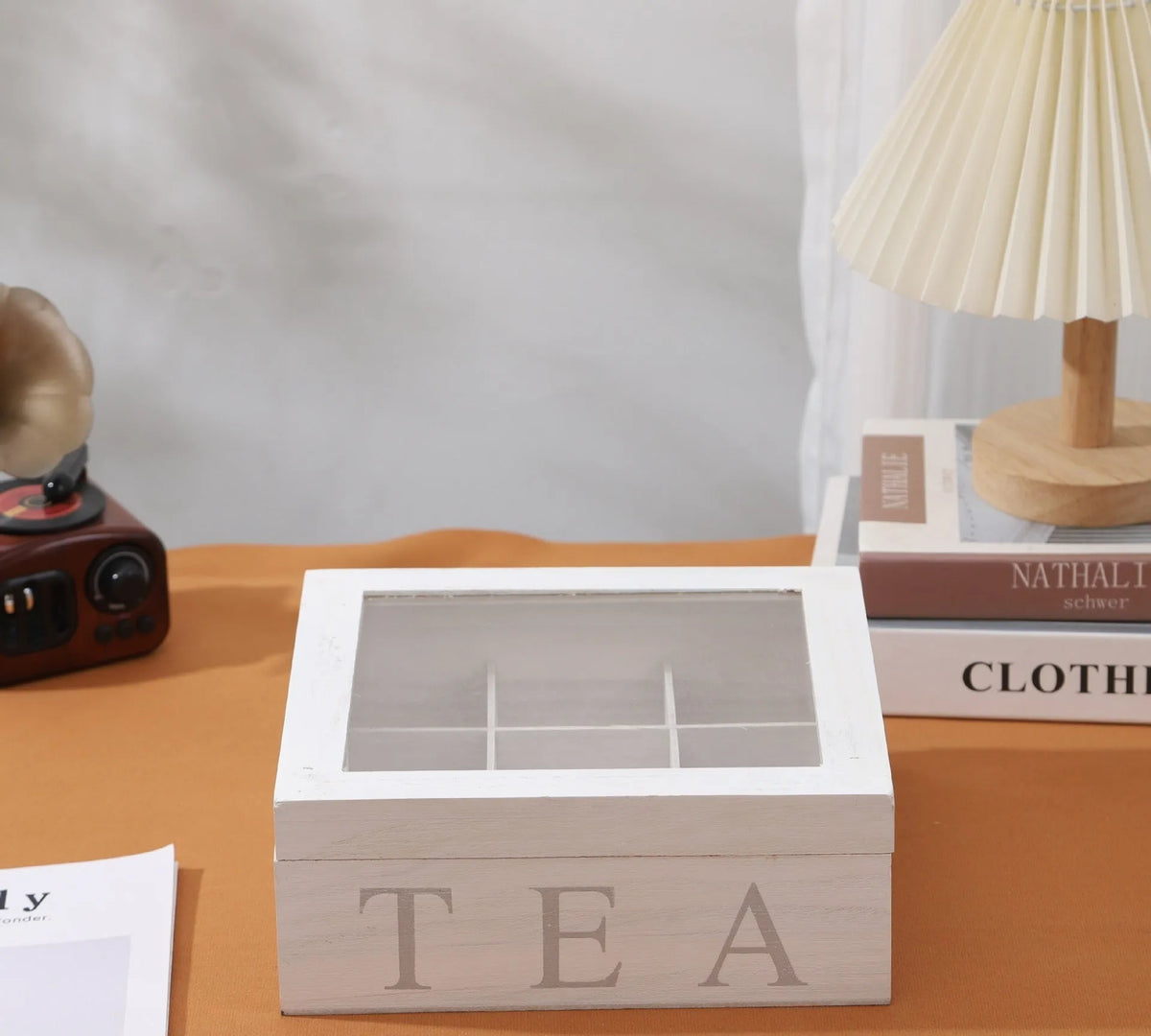 White wooden multi-grid coffee storage box with transparent cover on a desk