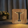 Solid wood hollow LED night lamp warm white with USB cable on wooden surface
