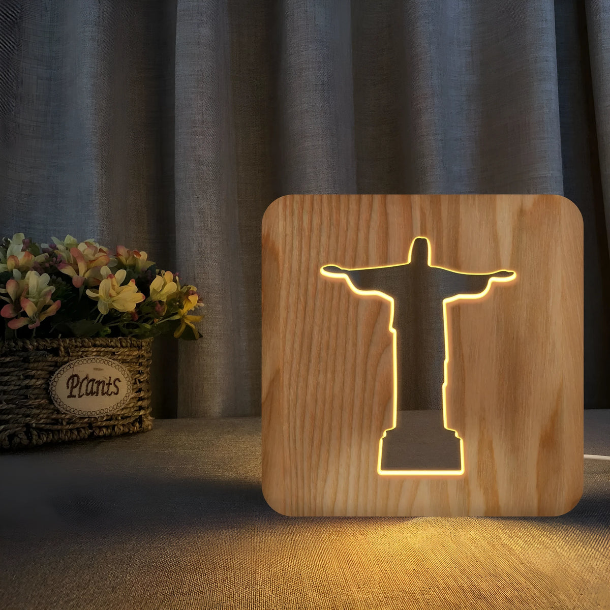 Solid wood hollow LED night lamp warm white with USB cable on wooden surface