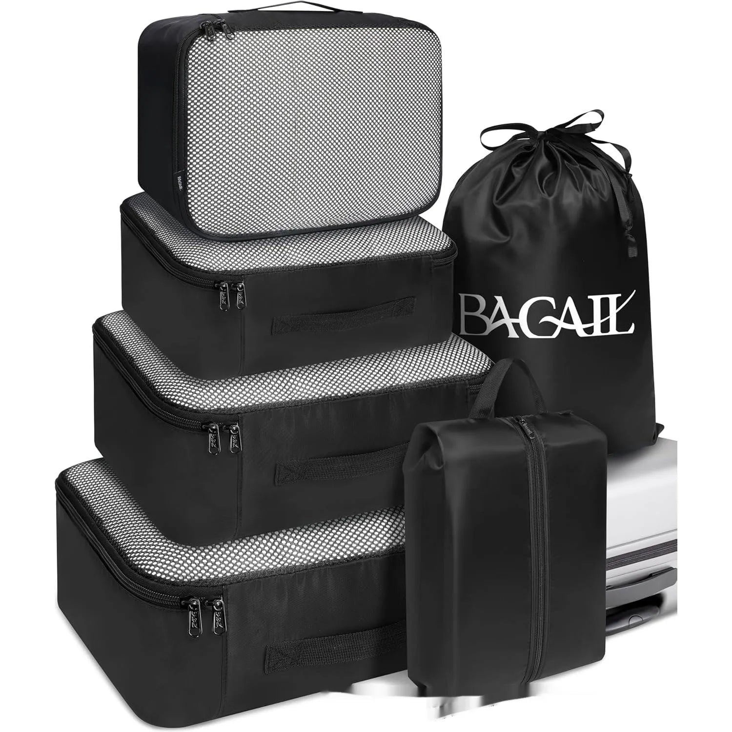 Set of eight cubic packing cubes for travel organisation in various colours including beige, black, and pink leopard print.