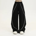 Black pleated wide-leg hip hop trousers with stripes, loose fit for sports.