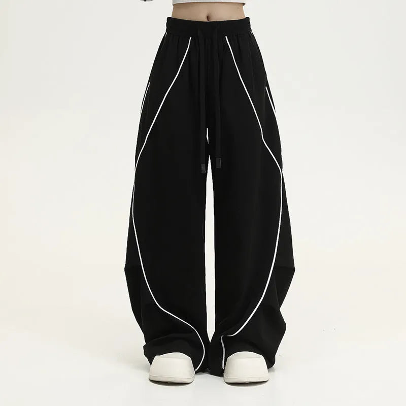 Black pleated wide-leg hip hop trousers with stripes, loose fit for sports.