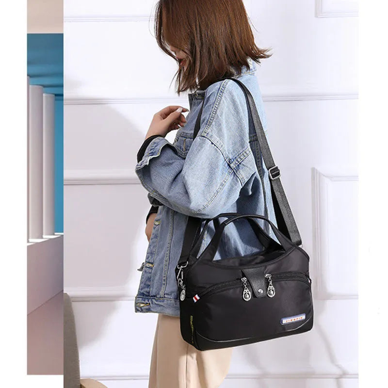 Women's anti-theft crossbody shoulder bag in Oxford cloth with multiple pockets and adjustable strap
