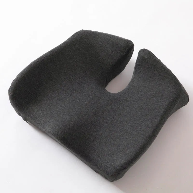 Memory foam office chair cushion with removable mesh cover in grey, shown on a desk chair.