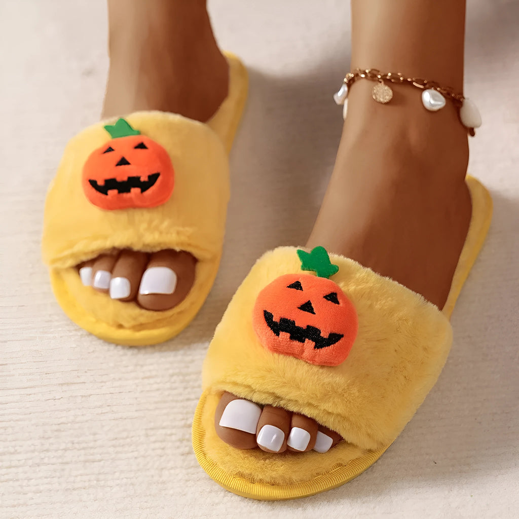 Yellow cartoon pumpkin plush slippers with open toe and anti-slip sole on a white background.
