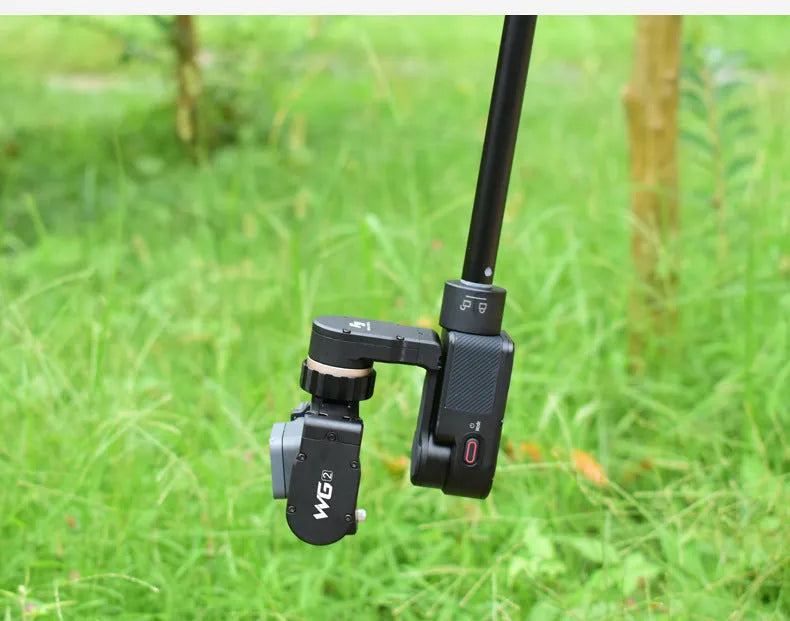 Black retractable selfie stick extended with smartphone attached in adjustable clamp