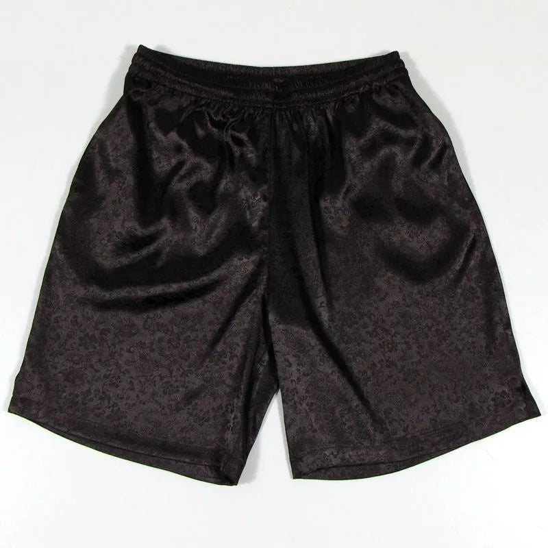 Men's black elastic waist Tang suit shorts for martial arts practice on a plain background