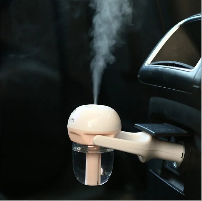 Compact blue car humidifier with rotating nozzle in vehicle cup holder