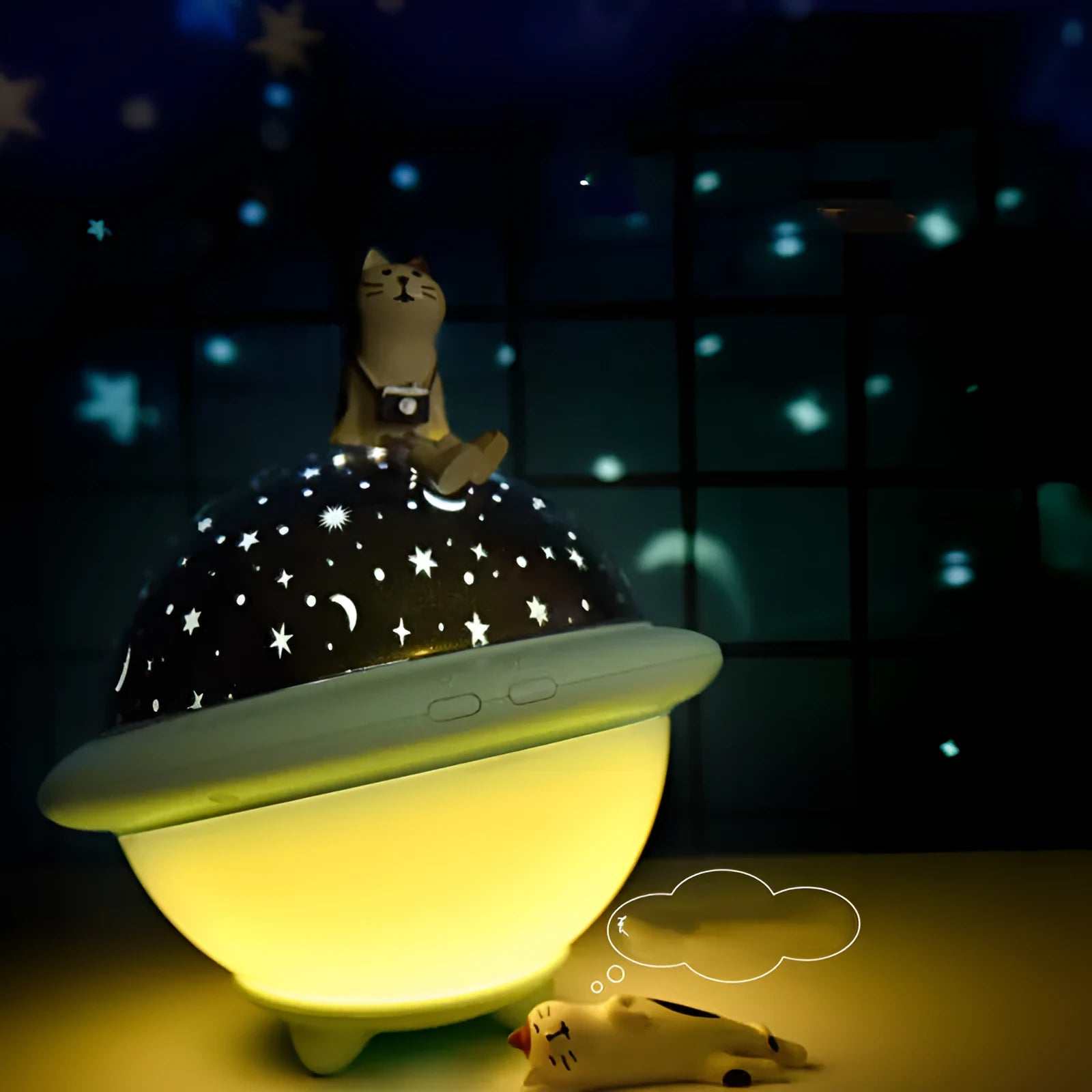 Green UFO-shaped plastic night light projecting a starry sky pattern on a wall.