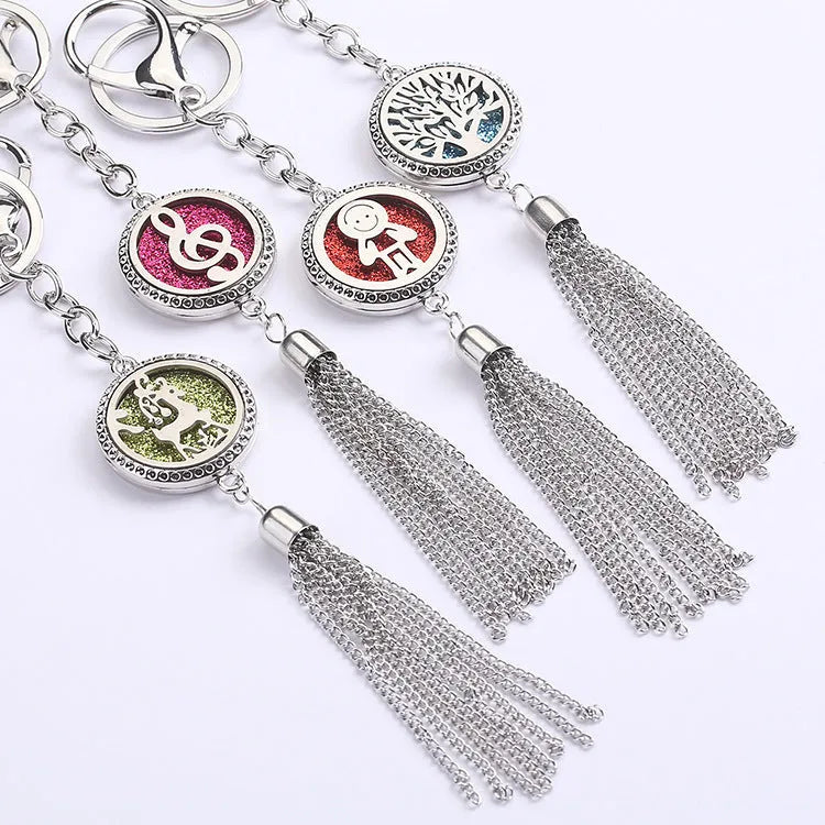 Tassel aromatherapy car pendant with alloy chain hanging from a rear-view mirror.