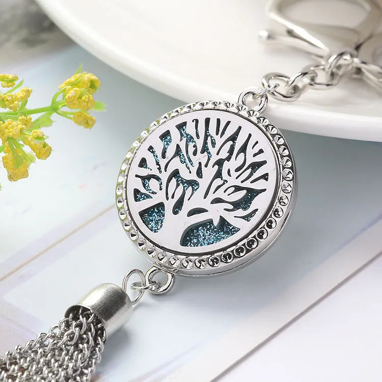 Tassel aromatherapy car pendant with alloy chain hanging from a rear-view mirror.