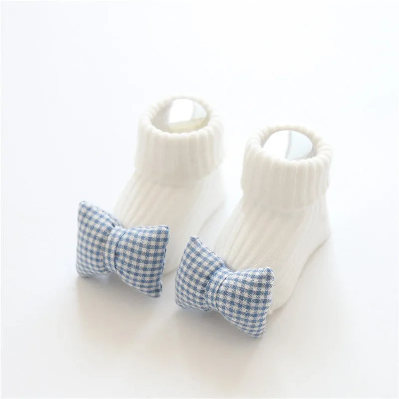 Cotton baby floor socks in various colours and patterns including bows, stars, and animal designs