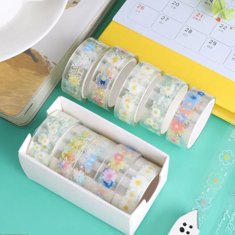 Five rolls of transparent decorative adhesive tape with Midsummer Daisy pattern, showing 1.5cm width