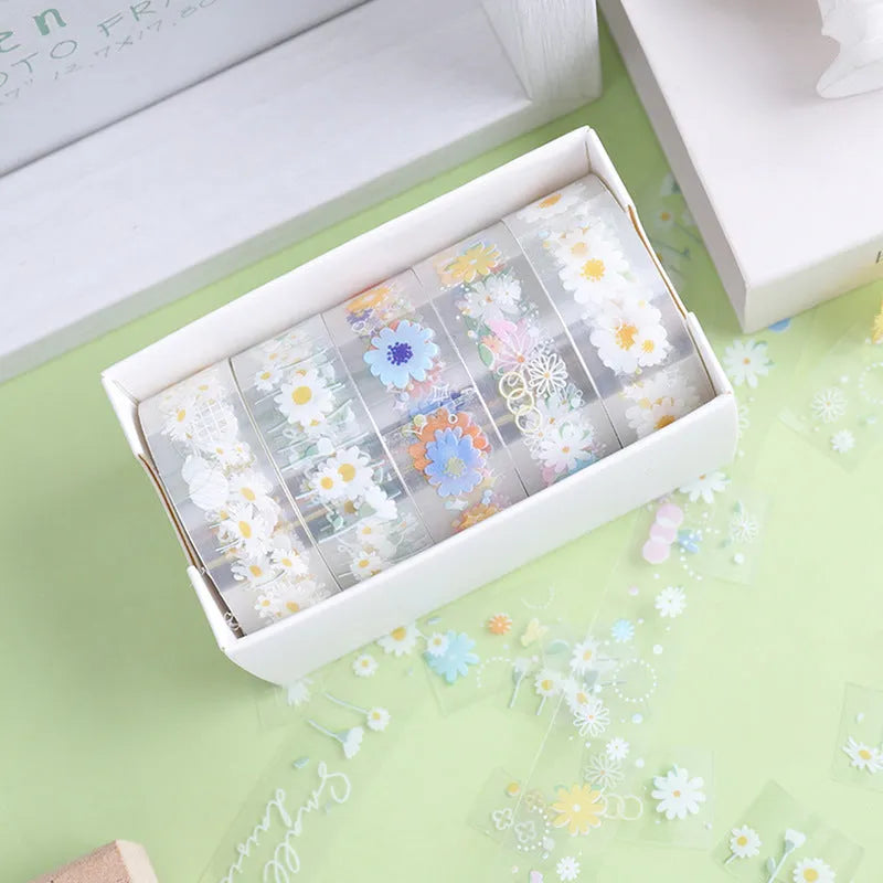 Five rolls of transparent decorative adhesive tape with Midsummer Daisy pattern, showing 1.5cm width