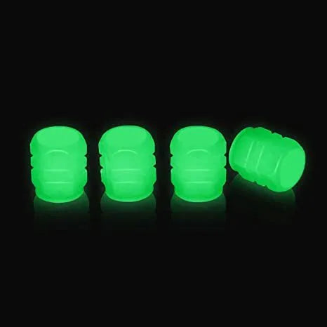 Set of luminous green and blue rubber tyre valve caps on a tyre valve stem.