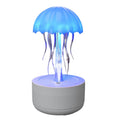 White jellyfish-shaped humidifier and essential oil diffuser with coloured LED lights and mist output.