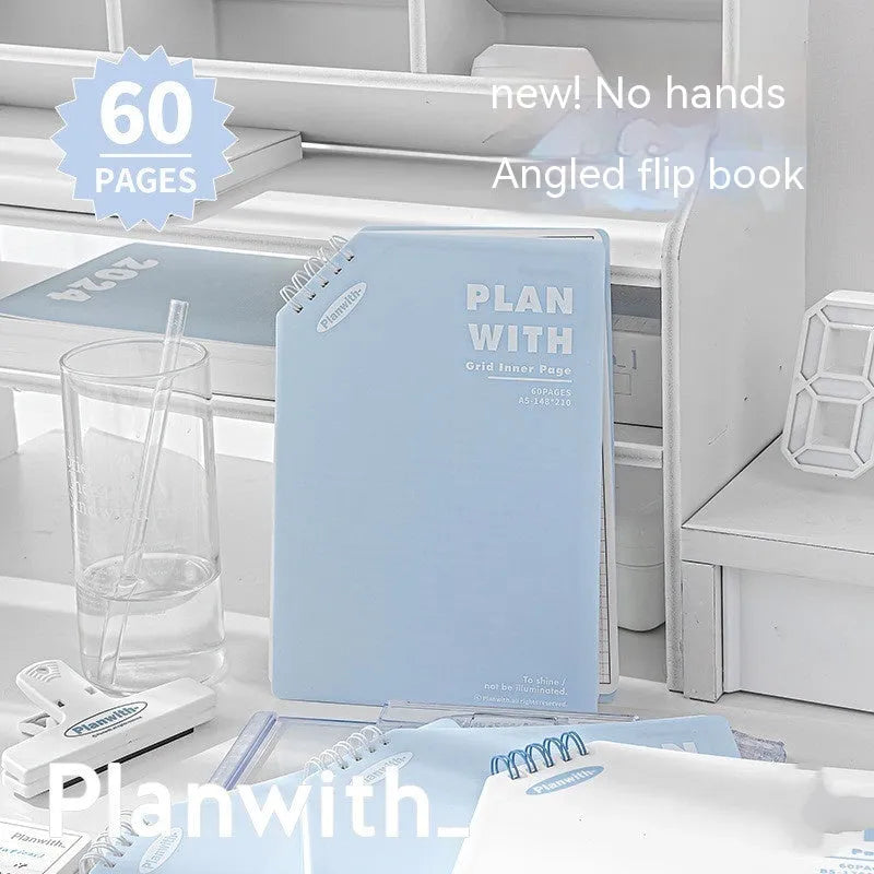 Oblique angle bound notebook in A5 or B5 size with a blue plaid or white cover, open to show pages.
