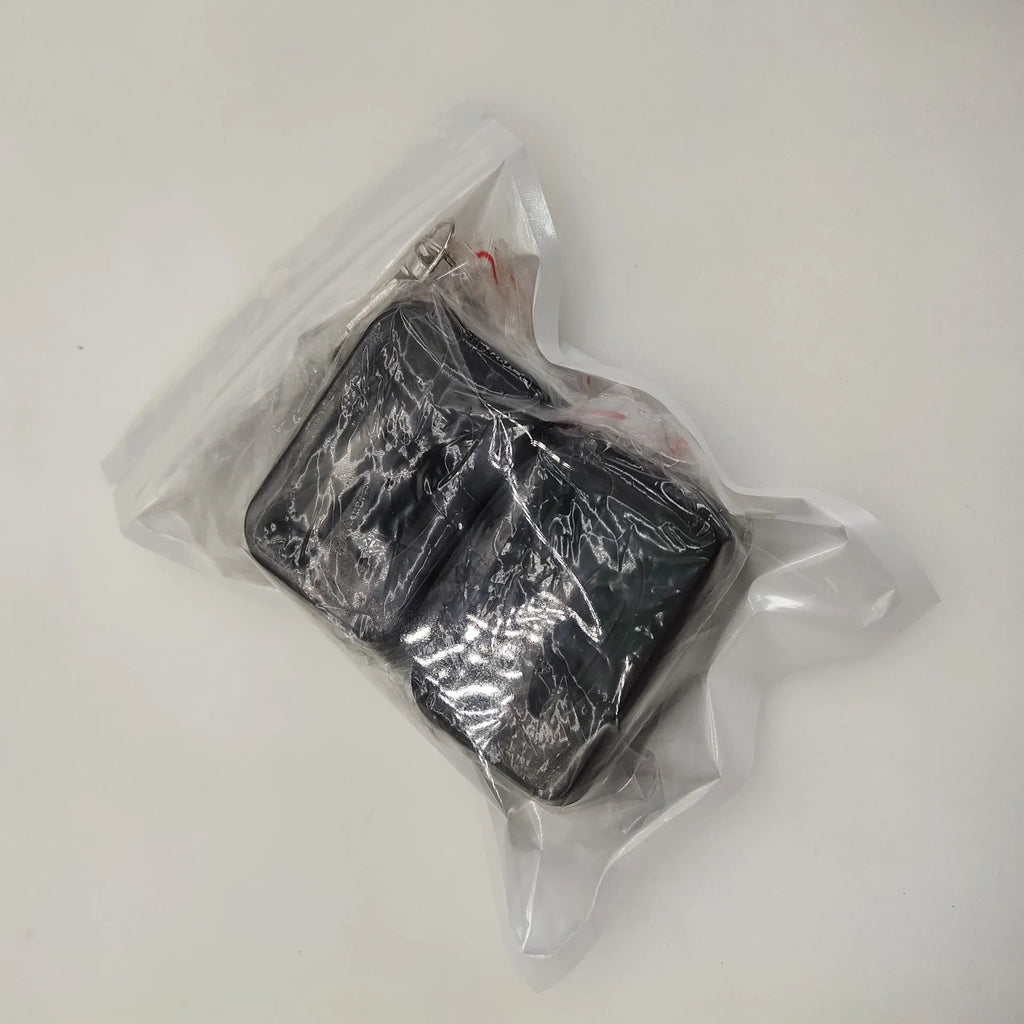 Black plastic seat belt lock catch protective device installed on automotive seat belt buckle