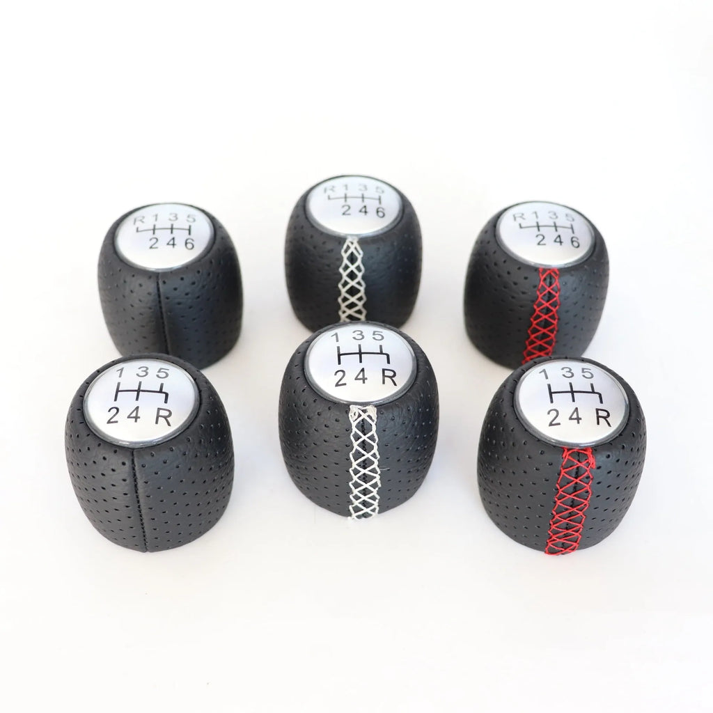 Sewn wrapped leather perforated style handball gear for Alpha vehicles in black, red, and white line options