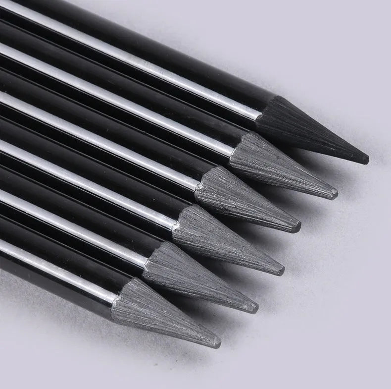 Set of six graphite and three carbonised drawing pencils with wooden casings on a white suction card.