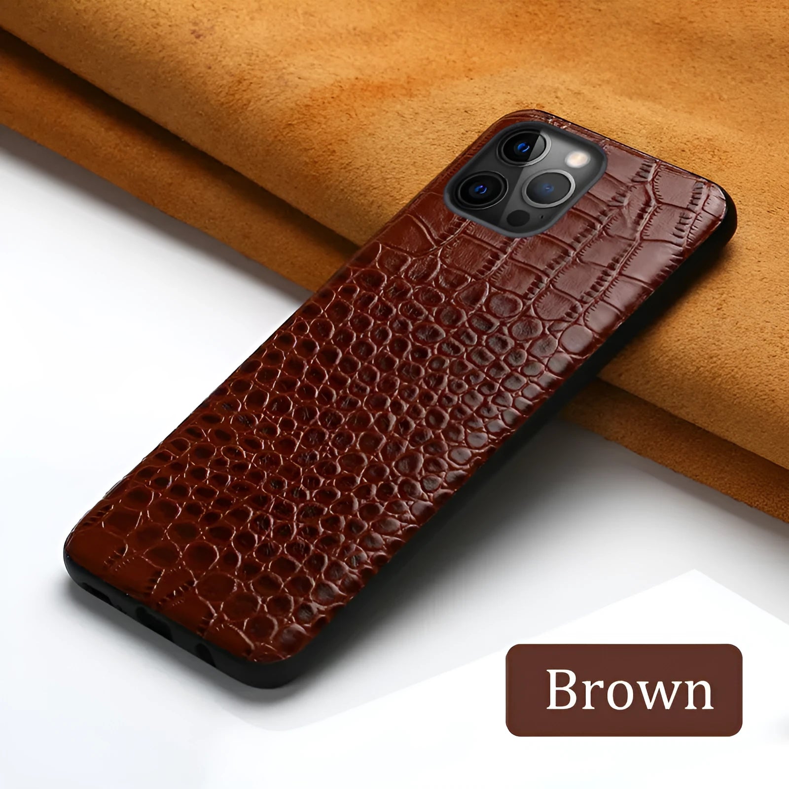 Handmade black leather iPhone case with a crocodile pattern texture on a table.
