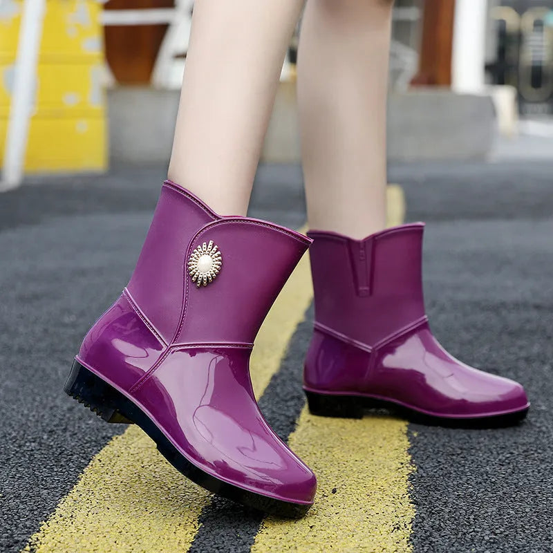 Women's mid-calf PVC rain boots in purple, black, or beige with a non-slip sole.