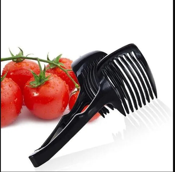 A black or green plastic tomato slicing holder on a kitchen worktop.