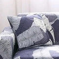 Geometric patterned stretch sofa slipcover on a double seat sofa with matching cushion