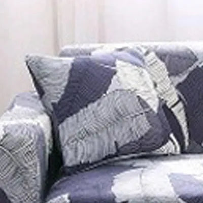 Geometric patterned stretch sofa slipcover on a double seat sofa with matching cushion