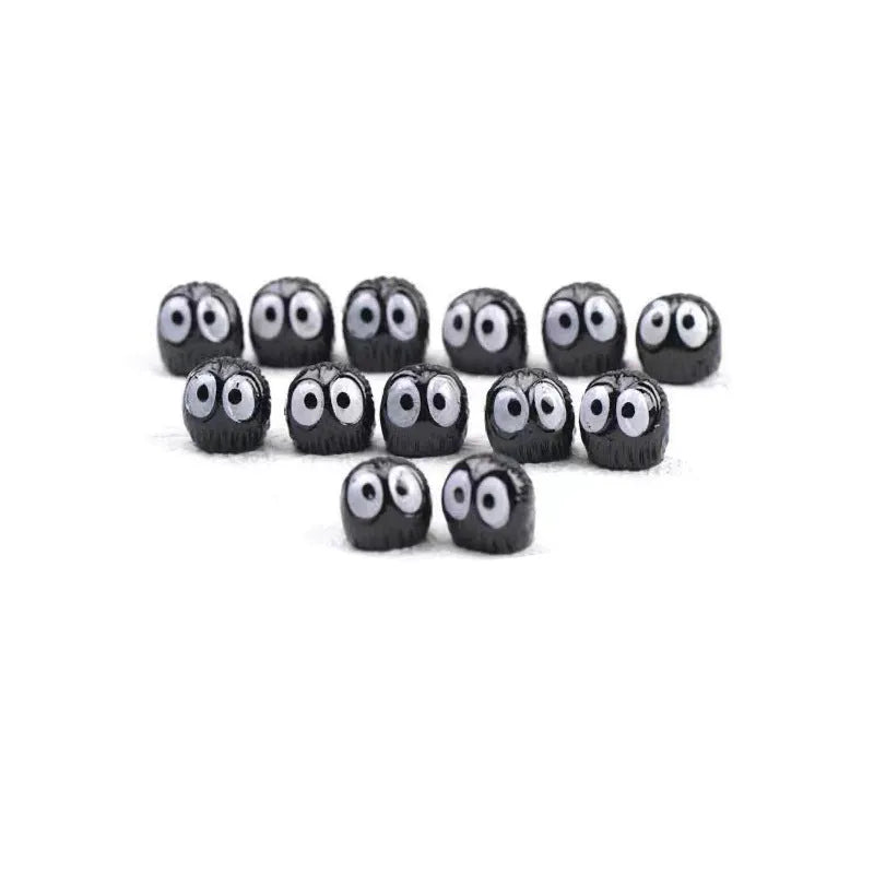 Cartoon black coal briquette resin decoration, approximately 1cm in size.