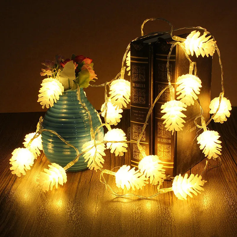 Warm white LED pine cone lights on a string, powered by batteries, for indoor and outdoor decoration.